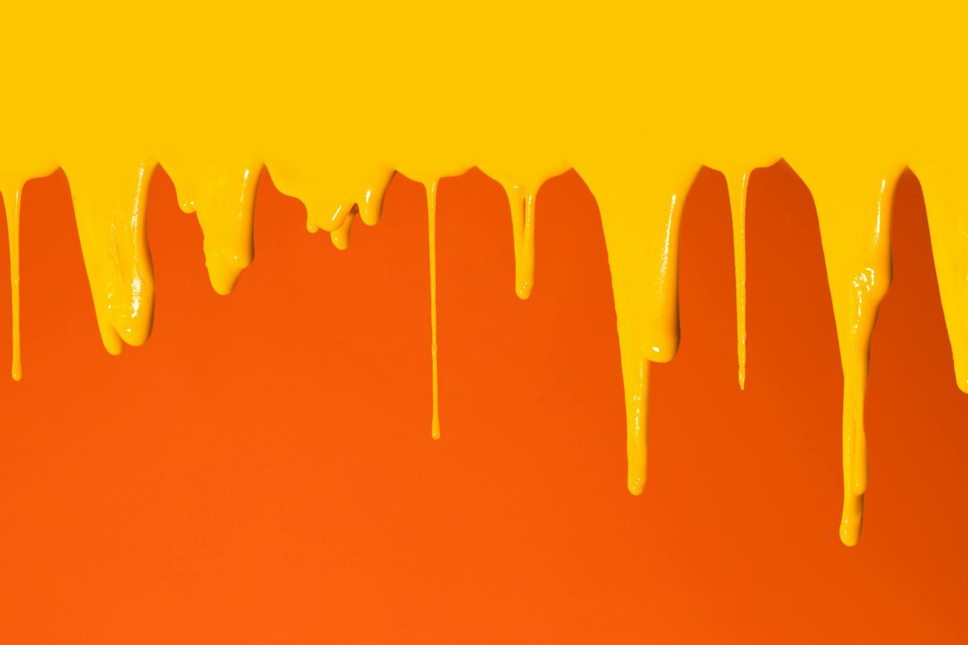 yellow paint dripping on orange surface
